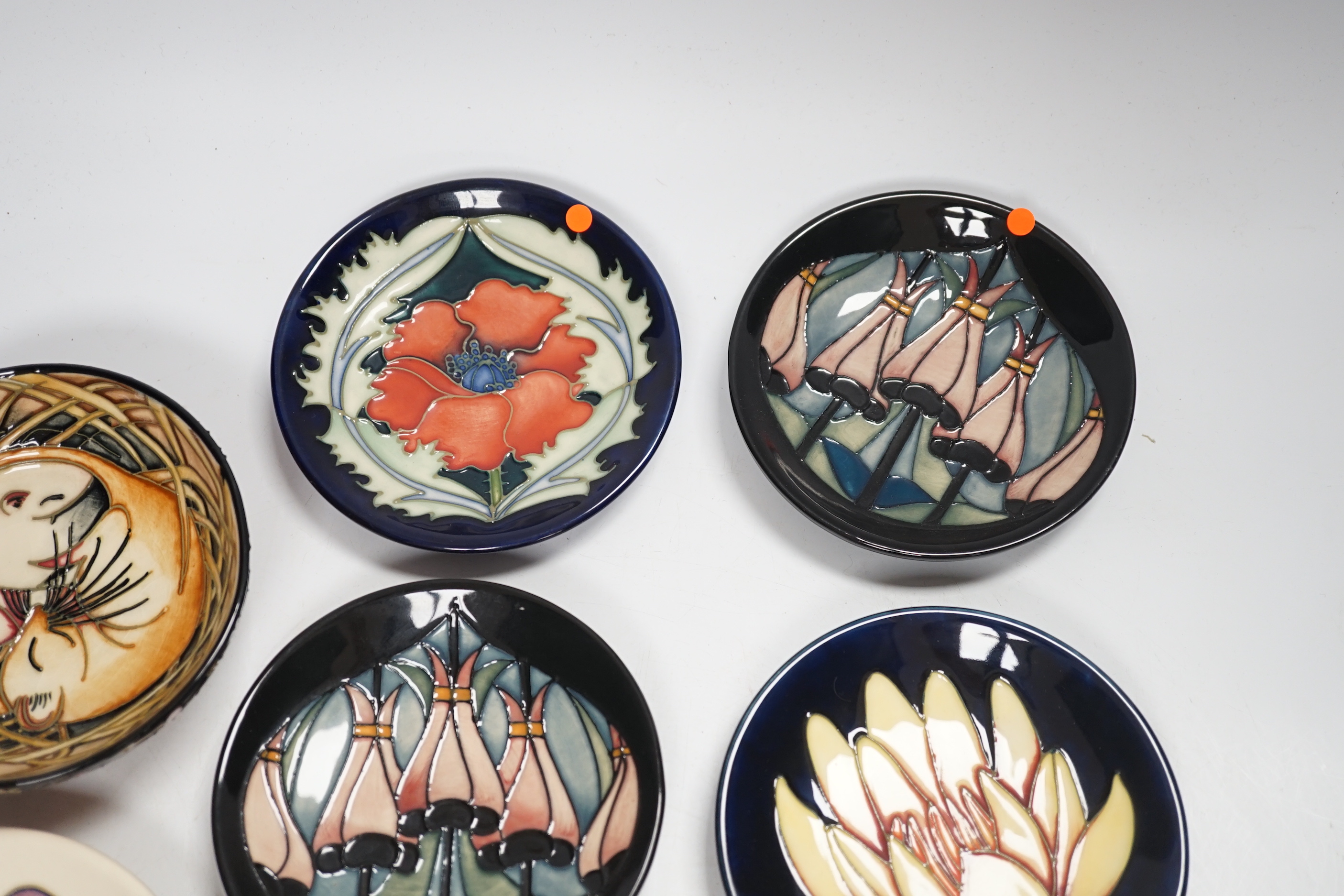 Seven Moorcroft floral dishes, two with Kerry Goodwin stamp to the base and a dormouse bowl designed by Emma Bossons, limited edition 14/100, 12cm in diameter